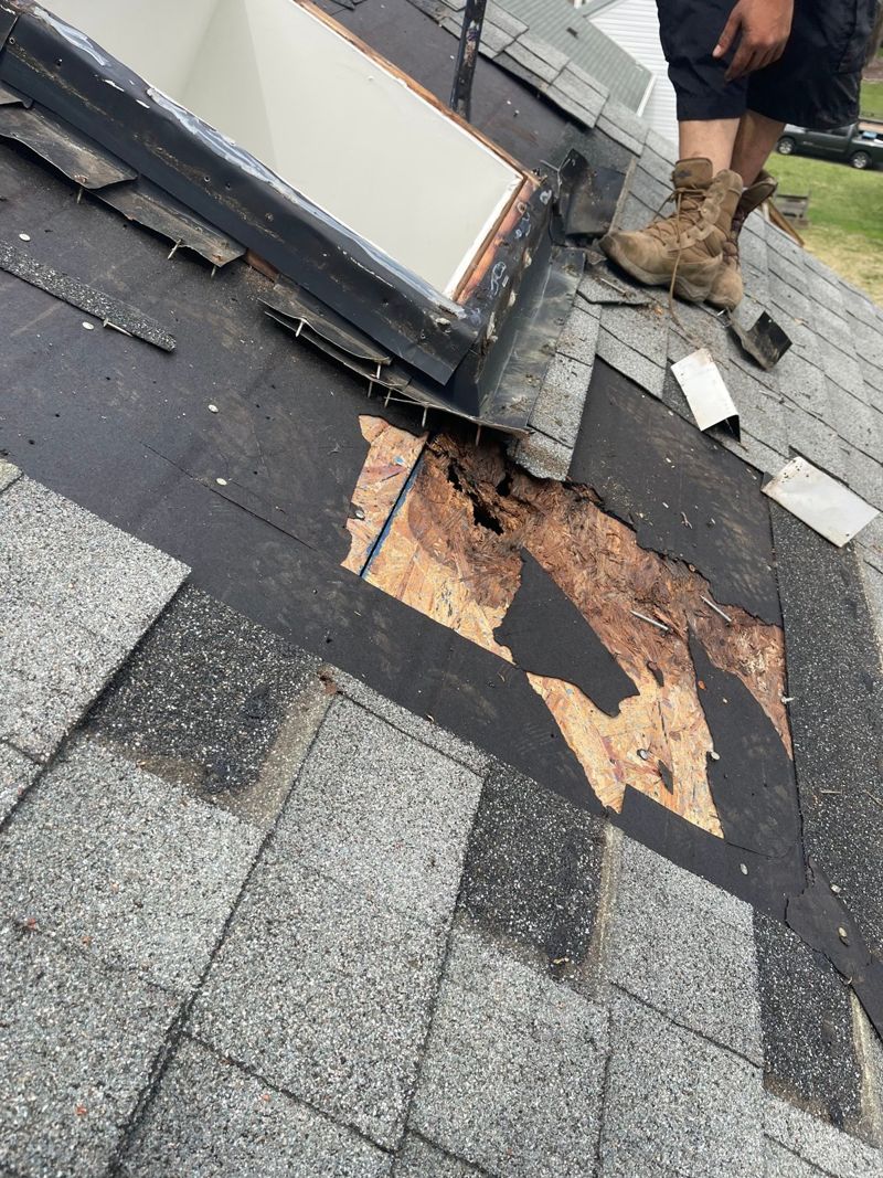 Deteriorated roof sheathing exposed beside a roof opening