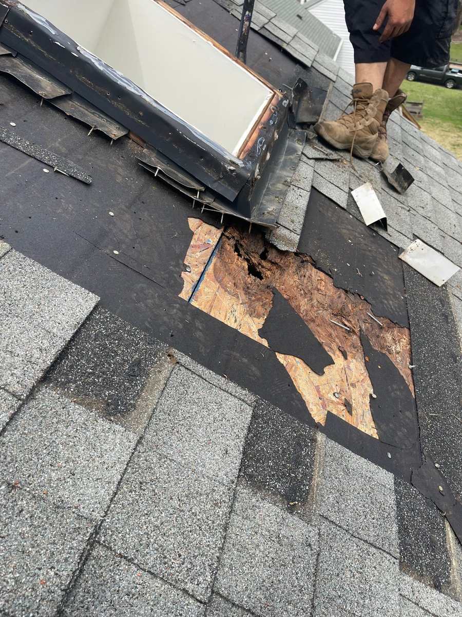 Deteriorated roof sheathing exposed beside a roof opening